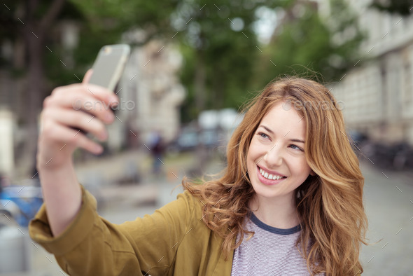 Happy Blond Girl Taking Selfie Photo at the Street