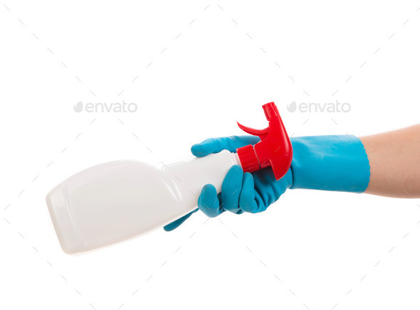 Hand holds spray bottle.