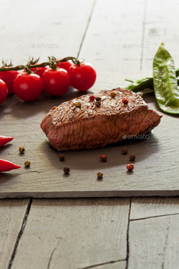 Delitious steak with vegetables over stone plate (Misc) Photo Download