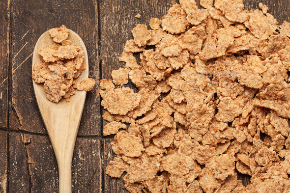 Corn flakes over old wooden table (Misc) Photo Download