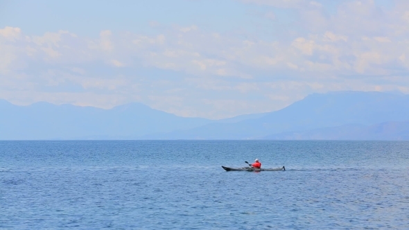 Man Rowing In Canoe In The Sea Man Rowing In Canoe In The Sea