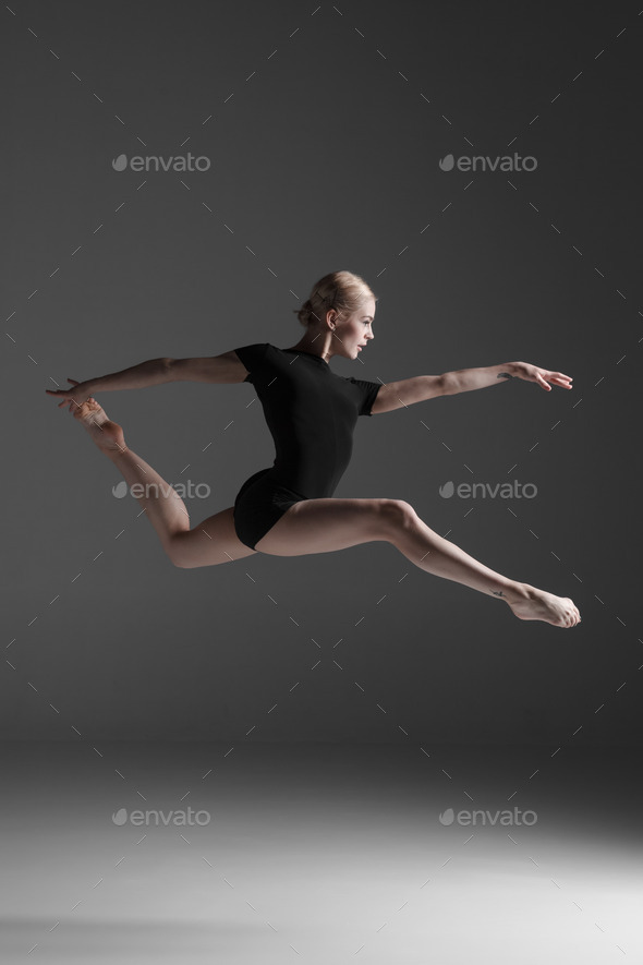 Young beautiful modern style dancer jumping on a studio background (Misc) Photo Download