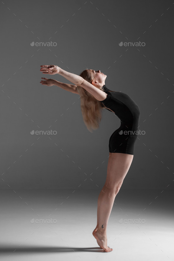 Young beautiful modern style dancer posing on a studio background (Misc) Photo Download