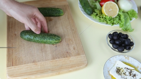 Hand Cutting Cucumber On Cutting Board With Sharp Hand Cutting Cucumber On Cutting Board With Sharp