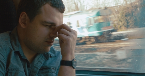 Man Taking a Headache Pill In The Train Man Taking a Headache Pill In The Train