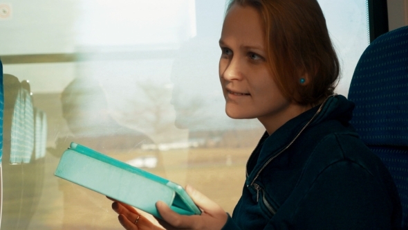 Woman Chatting On Tablet PC In Train Woman Chatting On Tablet PC In Train