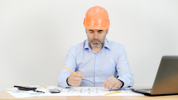 Engineer Working in Office on Blueprint Engineer Working in Office on Blueprint