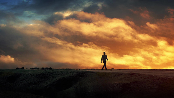 Man Walks On Horizon With Epic Cloudscape by RockfordMedia | VideoHive