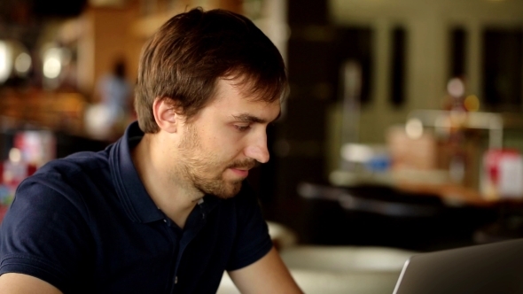 VideoHive a Man Sitting In a Cafe And Working At a Laptop 13525615 VideoHive a Man Sitting In a Cafe And Working At a Laptop 13525615