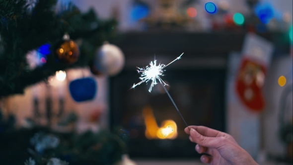 Sparklers On The Background Of Christmas Tree