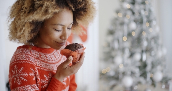 Young Woman Savoring a Christmas Cake