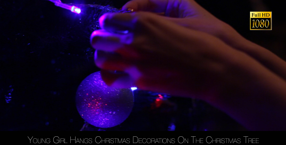 Young Girl Hangs Christmas Decorations On The Christmas Tree 2