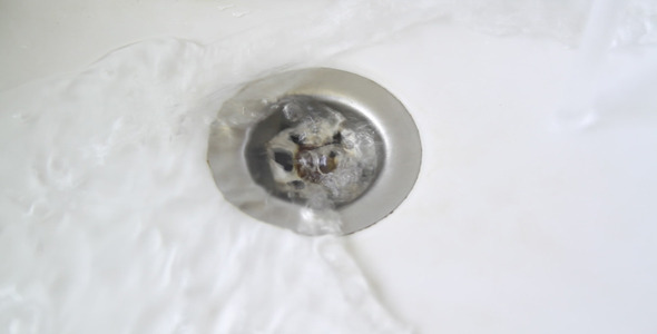 Water Drain in a White Sink Water Drain in a White Sink
