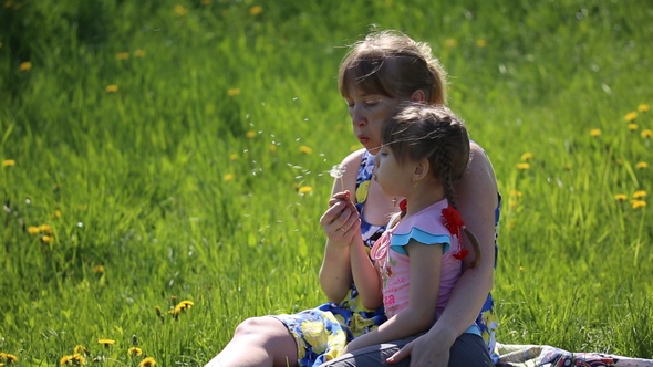 Videohive The Mother with Daughter Blowing on a Dandelion 16144297