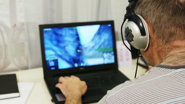 VideoHive Man Using Laptop Computer At Home A Man Playing a Computer Game With Headphones 17017774 VideoHive Man Using Laptop Computer At Home A Man Playing a Computer Game With Headphones 17017774