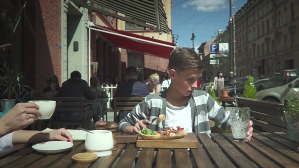 VideoHive Boy Sitting In Outdoor Cafe 17033815 VideoHive Boy Sitting In Outdoor Cafe 17033815