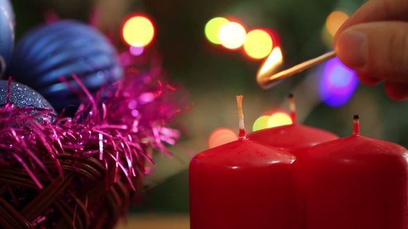 A Man Lights a Christmas Candle.