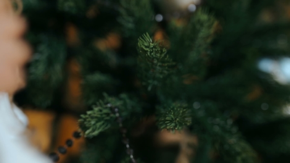 Woman Decorating The Christmas Tree