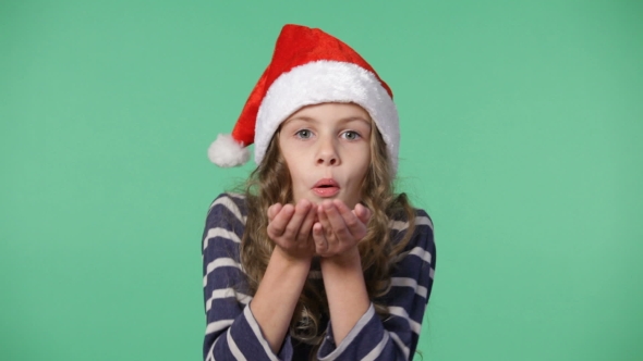 Little Girl In a Christmas Cap Throwing Up Confetti