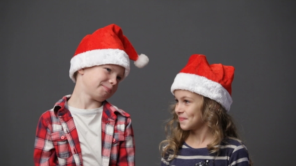 Little Girl And Boy In Christmas Caps