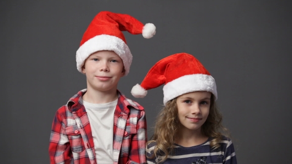 Little Girl And Boy In Christmas Caps