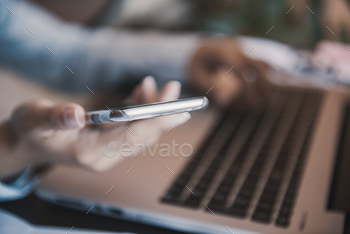 Photodune Artistic view of mobile technology at home: girl using a mobile phone and a laptop. 18478104
