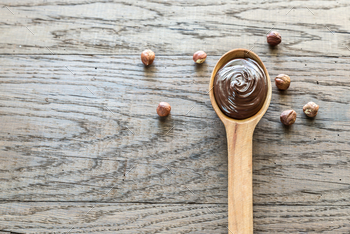Photodune Wooden spoon of chocolate cream with hazelnuts 18753227