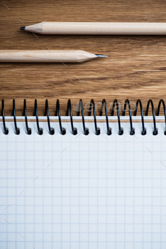 Photodune Notebook and pencil on a wooden table 18783868