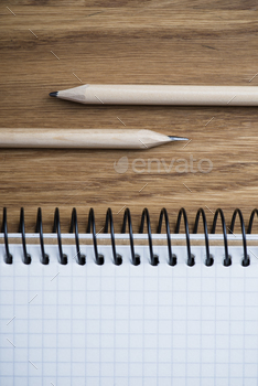 Photodune Notebook and pencil on a wooden table 18783867