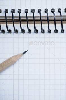 Photodune Notebook and pencil on a wooden table 18783877