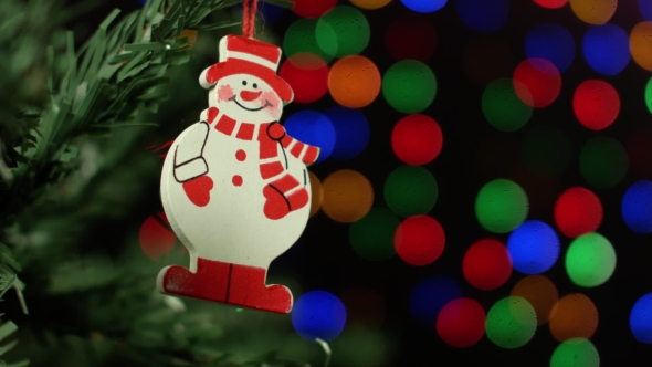 Christmas Background With Christmas Tree And Snowman On Background Of Blurred Lights