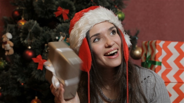 Woman Shakes The Christmas Gift Box