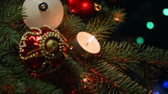 Christmas Decorations on the Christmas Tree with Candles on a Background Garlands