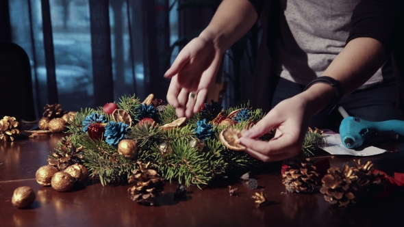 Crop Hands Decorating Christmas Wreath