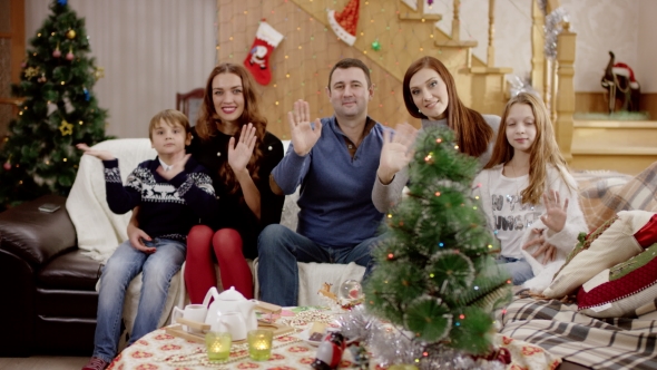 Happy Family Waving at Camera at Christmas Party