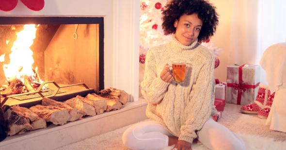 Happy Young Woman Relaxing at Christmas
