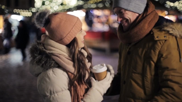 Happy Couple with Coffee Outdoors on Christmas