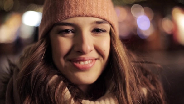Happy Young Woman in Winter Hat on Christmas
