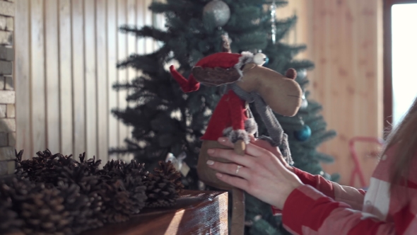 Woman Decorating Living Room for Christmas