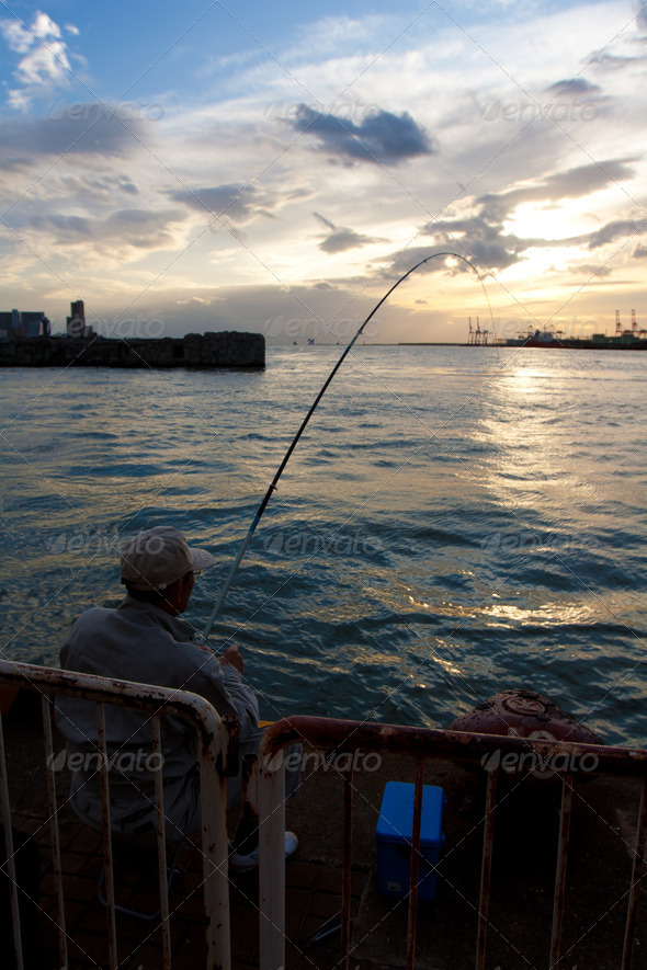 Man fishing during sunset