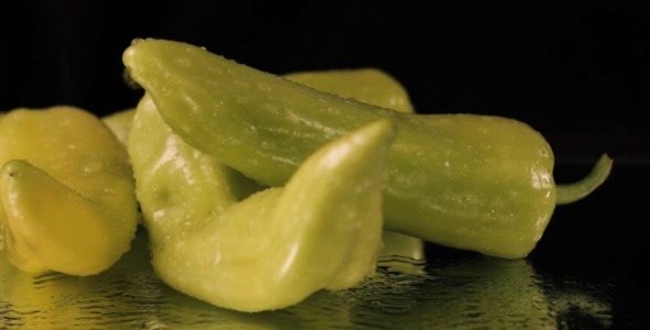 Wet Green Peppers Rotating On Black Wet Green Peppers Rotating On Black