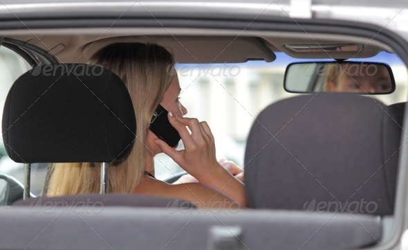 Woman driver talking on her mobile phone