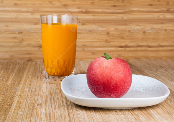Whole Fresh Peach on Plate with Peach Drink