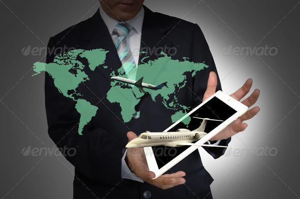 Business Man present flight trip around the world over tablet PC