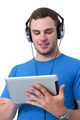 Young man with headphones working on a tablet pc Young man with headphones working on a tablet pc - PhotoDune Item for Sale