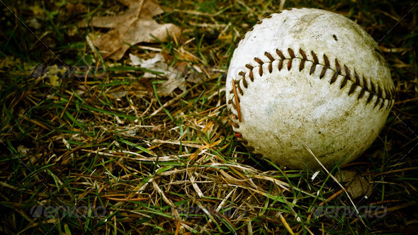 Old baseball left outside in autumn