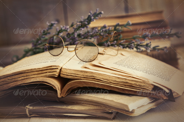 Old books open on wooden table