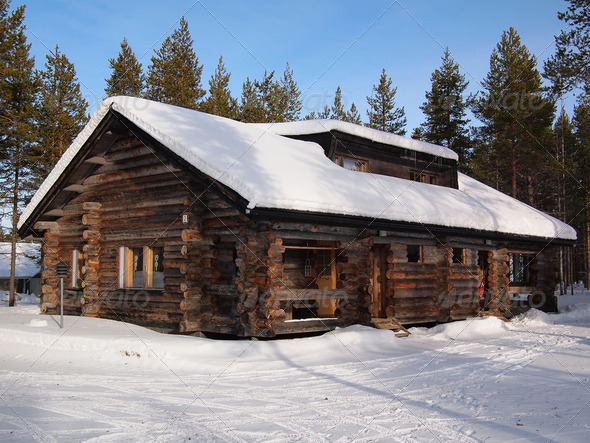Snow-covered log cabin