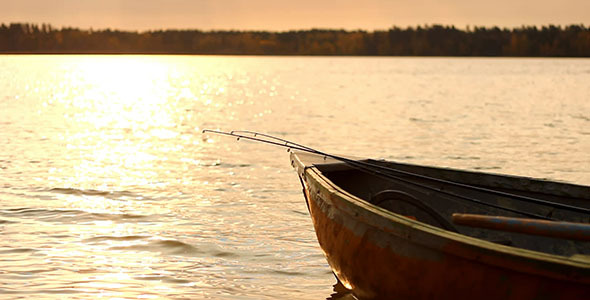 Fishing Wooden Boat With Rods At Sunset Fishing Wooden Boat With Rods At Sunset