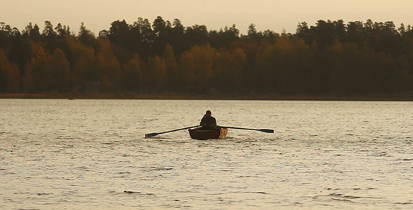 Rowing Fisherman On Wooden Boat Rowing Fisherman On Wooden Boat